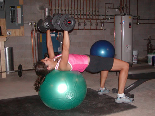 Julie performing a Dumbell Swiss Ball Chest Press